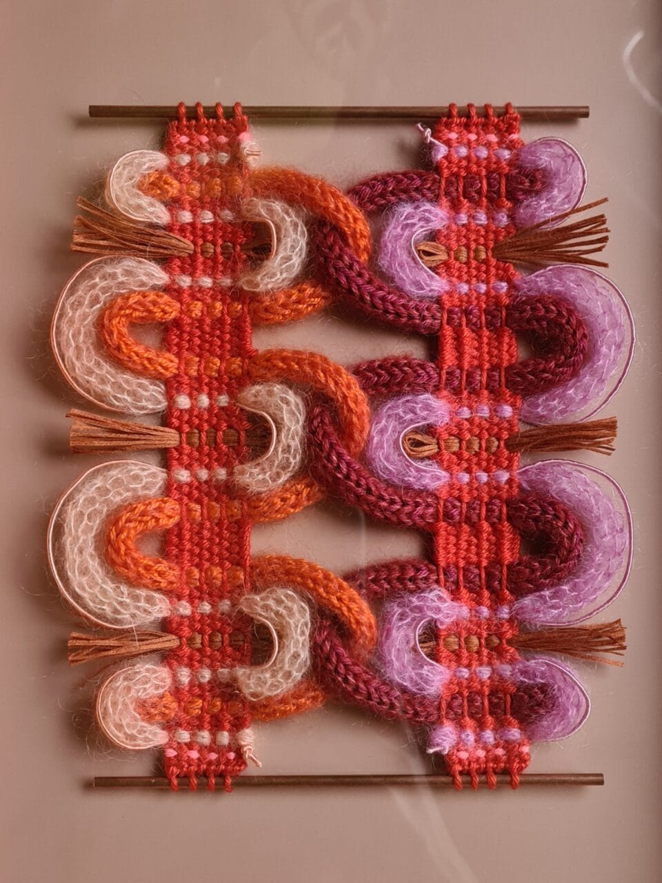 vibrant textured fibers woven in the style of passementerie while incorporating geometric, curving forms